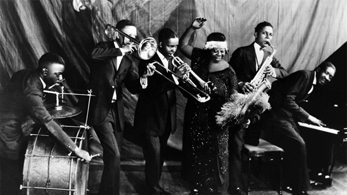 Ma Rainey Georgia Jazz Band posing for a studio group shot in the mid-1920s, with Thomas A. Dorsey at the piano.